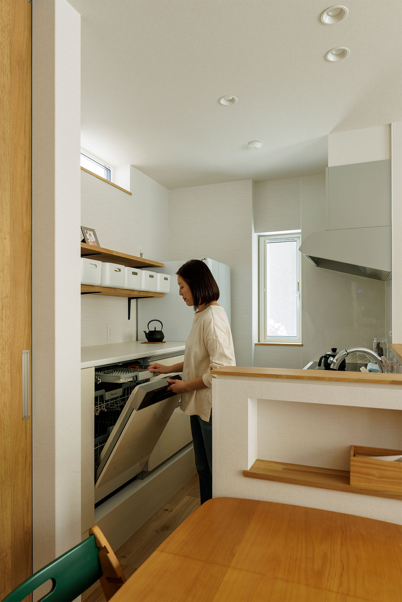 ご夫妻の要望で、キッチンの背面収納にミーレの大型の食器洗い乾燥機を組み込んだ。洗い物の出し入れがスムーズにできるよう、天板はあえて高めに設計